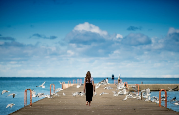 Woman standing at the end of a dock