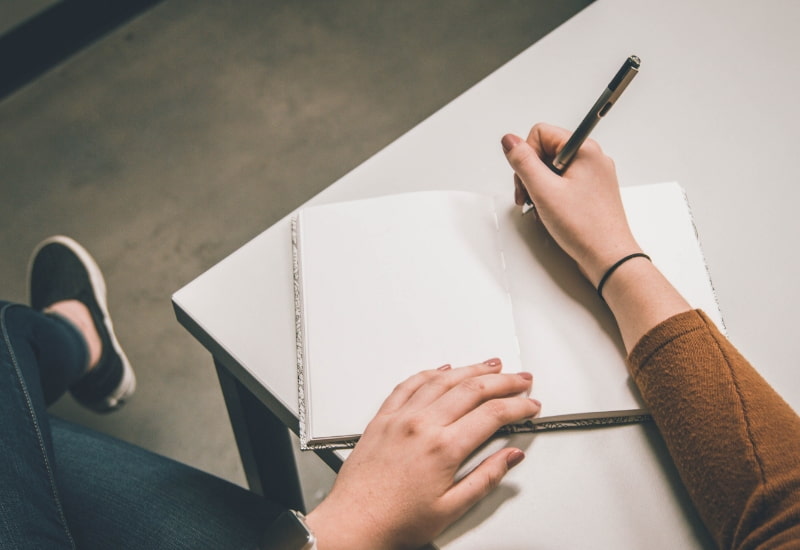 woman writing in notebook