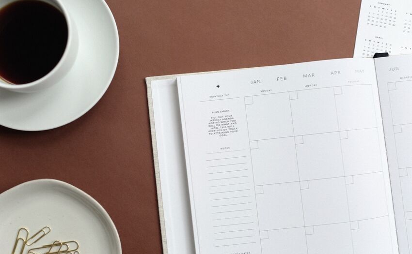 planner on the table with a cup of coffee