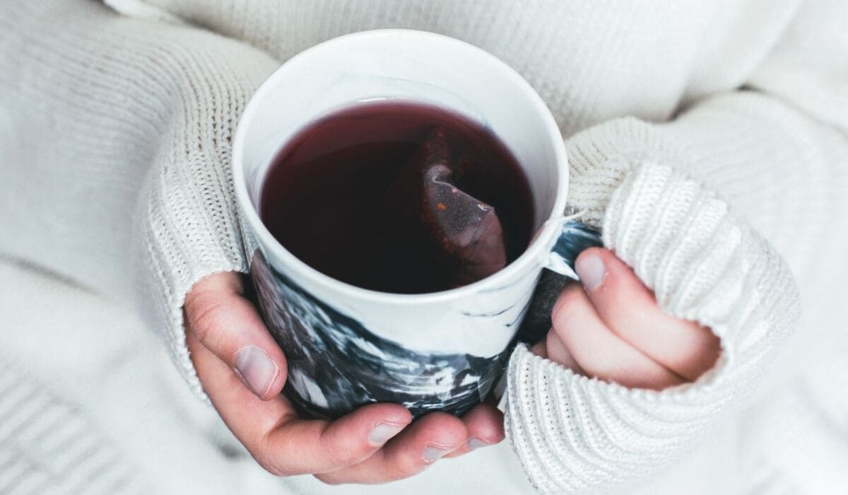 Natural cold remedies - woman holding a cup of tea