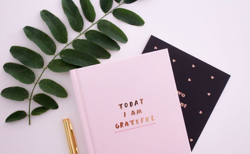 Apps That Make You Happy - pink notebook with the word "gratitude" on it