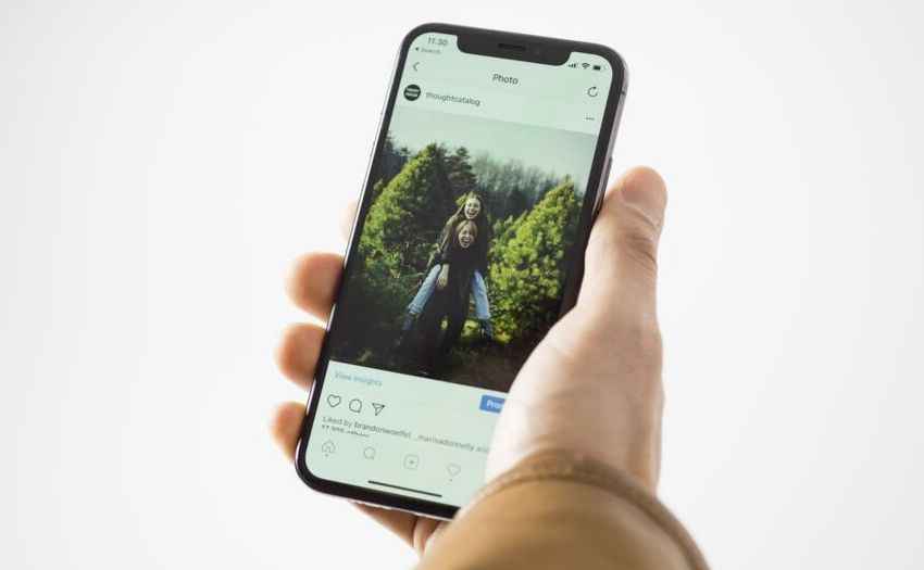 Job application mistakes - hand holding a phone showing Instagram account