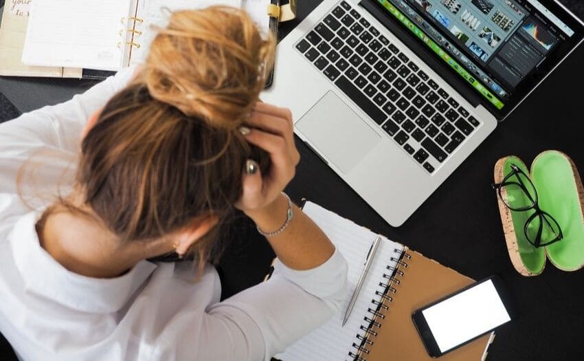Job application mistakes - girl frustrated in front of her computer