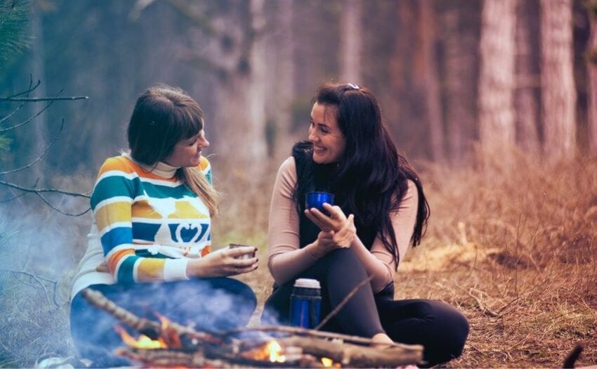 two women having tea in the woods