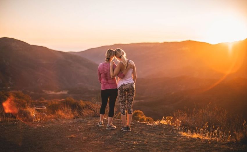 two women watching sunset