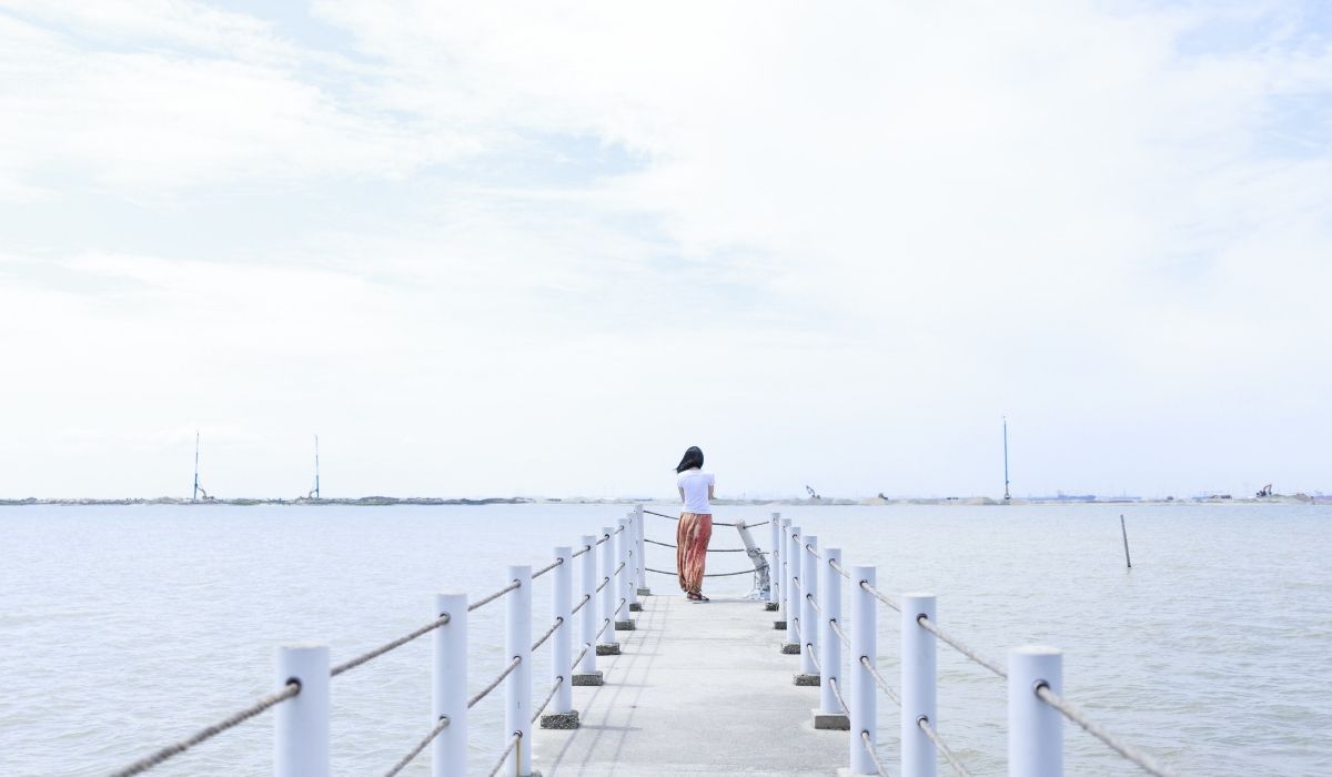 Woman standing at the end of a dock