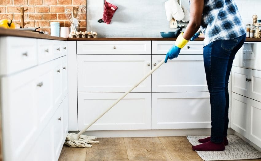 person mopping the kitchen floor