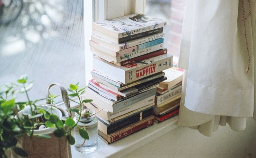 Stack of books by a window