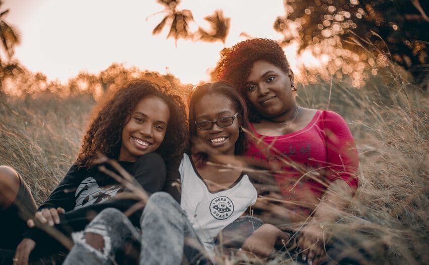 three women smiling to the camera