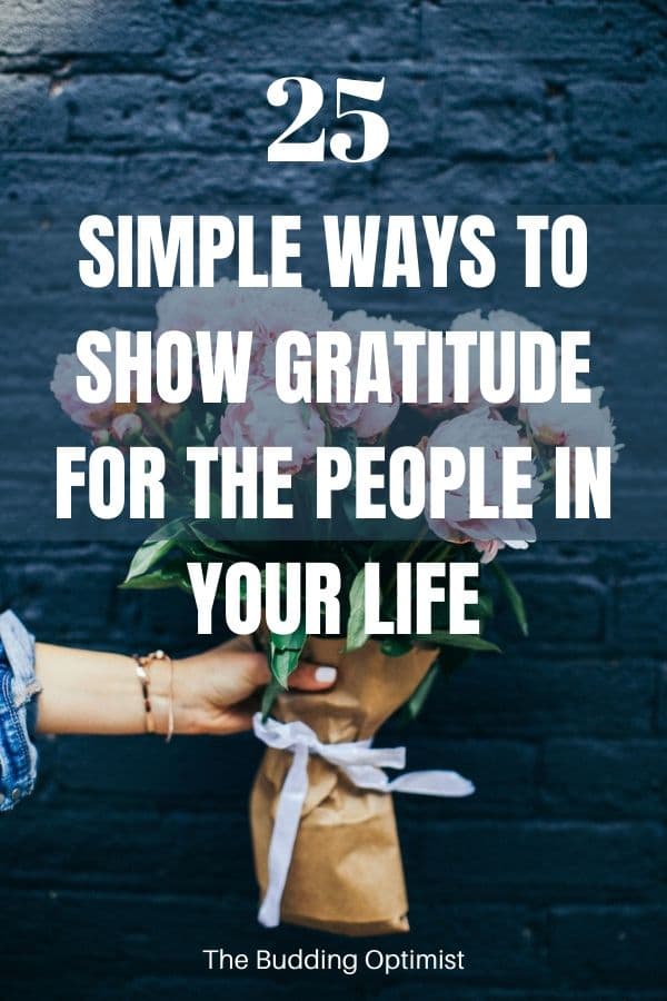Ways to show gratitude Pinterest image hand holding a bouquet of flowers