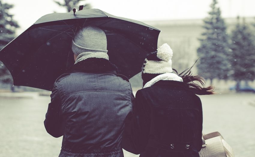 rainy day date ideas couple walking under an umbrella