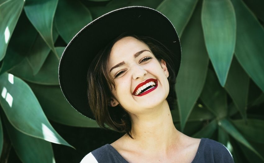 woman with a hat smiling