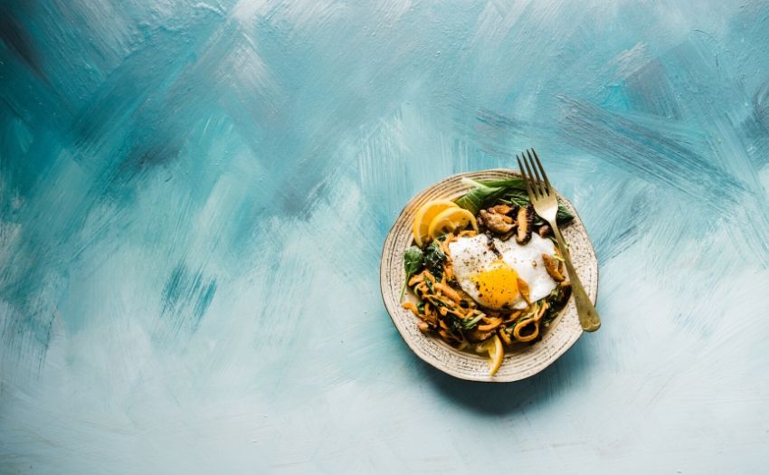 a plate of food with eggs and oranges