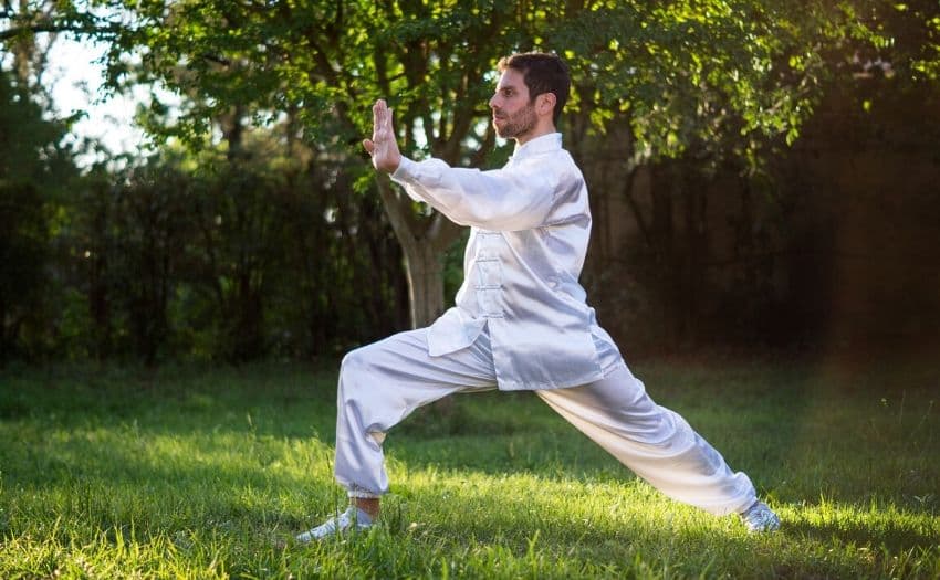 Man dressed in white practicing qigong