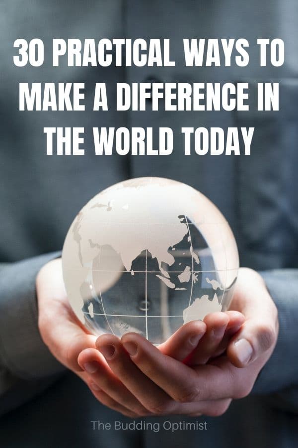 how to make a difference Pinterest image a hand holding a glass world globe
