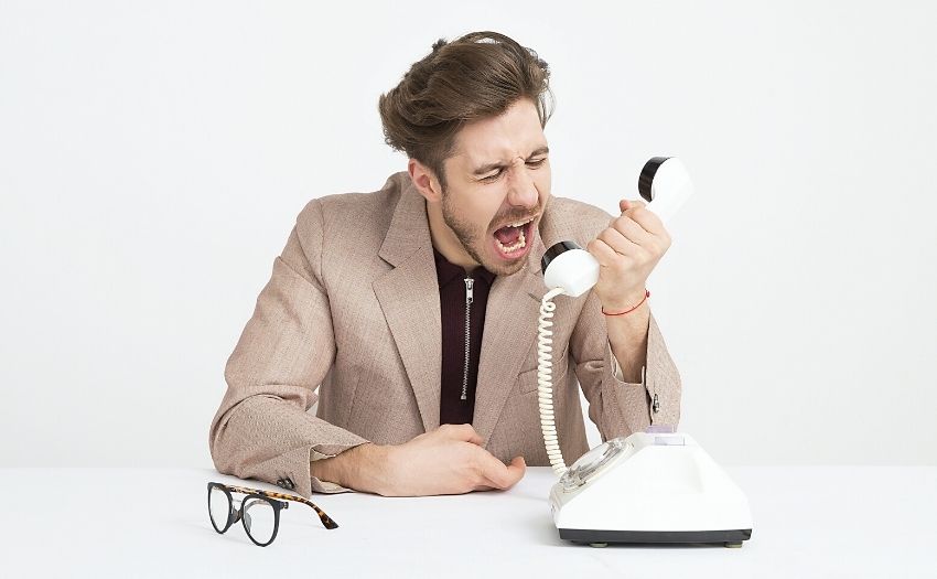 man yelling into a telephone