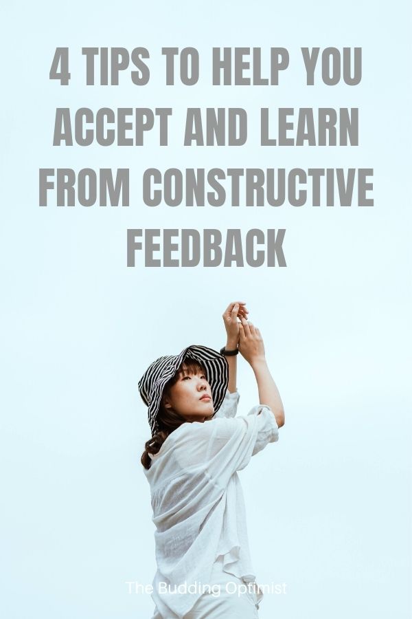 Constructive Criticism Pinterest image of a woman wearing a hat with text overlay