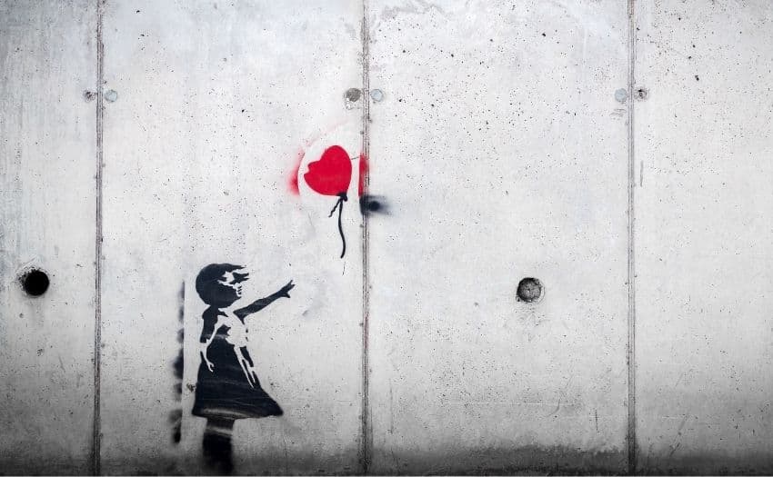 Picture of a little girl with a red heart balloon on the wall